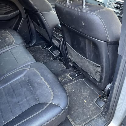 Car rear footwell prepared for an interior clean