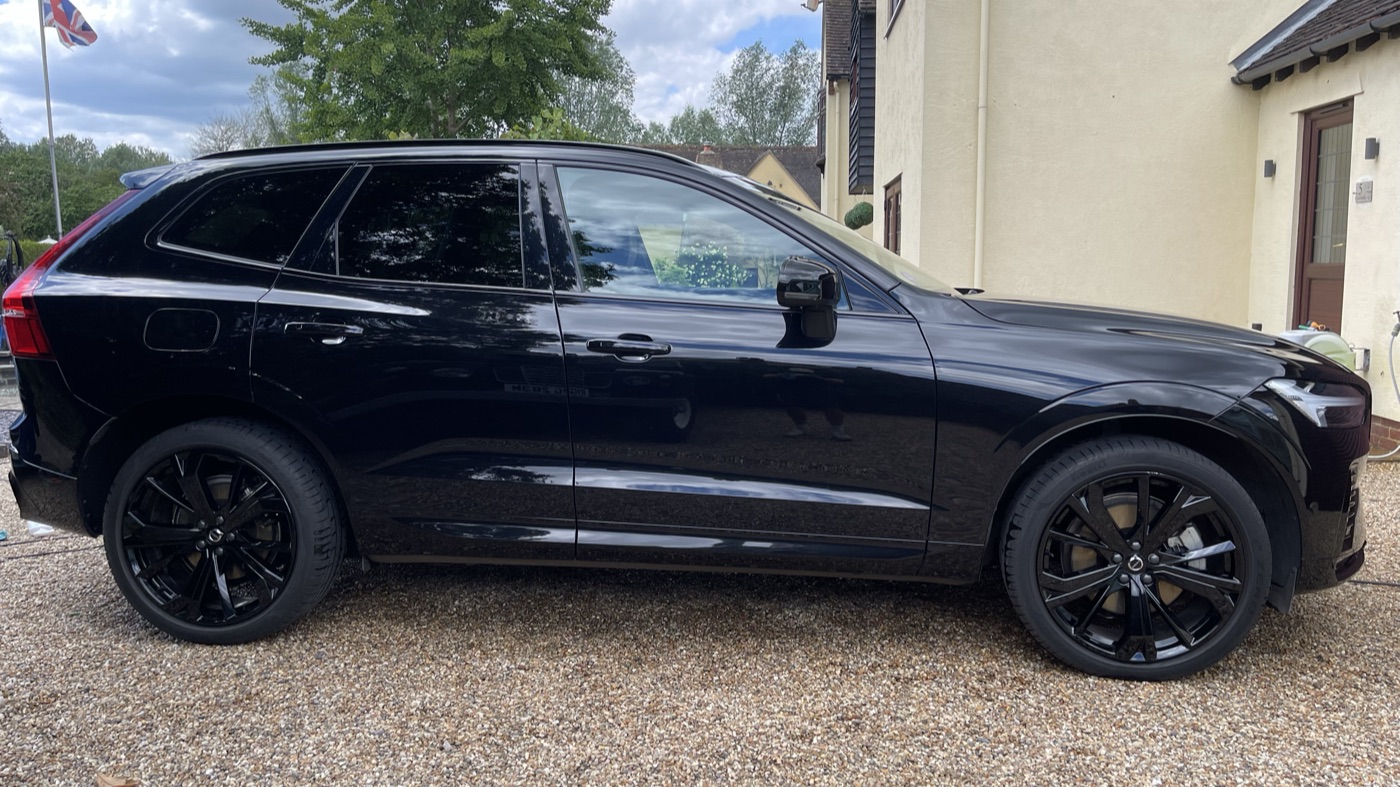 Glossy black Volvo SUV after a mobile exterior wash